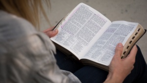 A woman reading a Bible.