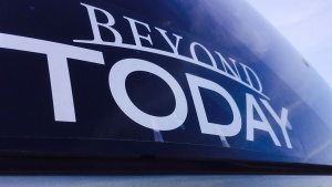 Beyond Today bumper sticker on a car window.