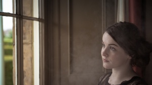 A young woman looking out a window.