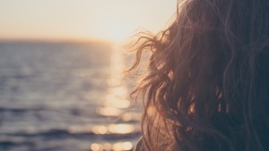 A young woman looking out over the ocean.