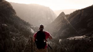 A man hiking on a mountain trail.