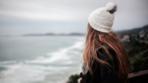 A young woman looking out over the ocean.