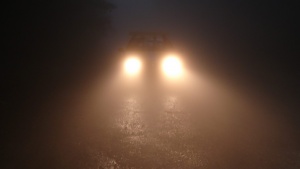 Bright car headlights in the dark.