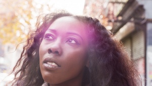 A young woman walking and looking up.