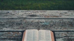 An open Bible laying on a table.