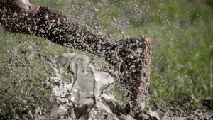 A person running through a mud puddle.