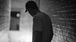 A man in a dark hallway.