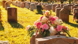 Headstones and flowers at a cemetery. 