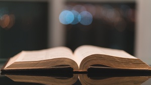 An open Bible laying on a table.