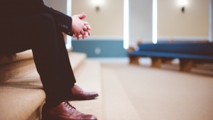 A man sitting inside a church.