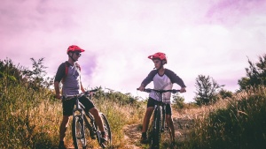 A dad and son riding mountain bikes.