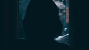 A woman looking out a window.