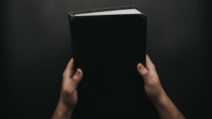 A person holding a Bible.