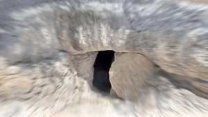 A tomb with round stone in the doorway.