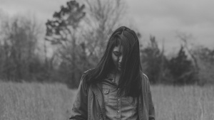 A woman walking in a field.