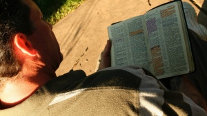 A man reading a Bible.