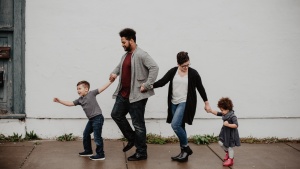 A family walking down a sidewalk. 