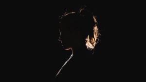 A silhouette of a young woman.