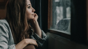 A woman looking out a window.