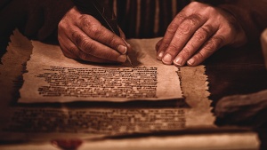 A photo illustration of man writing in a scroll.