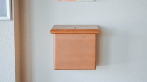 A box attached to the wall where one could drop in money at a church.