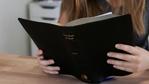 A woman reading a Bible.