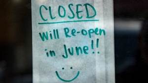 A handwritten note on business store door that its closed till June.