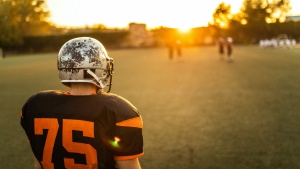 Football player on field at sunset