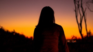 A woman watching the sunset.