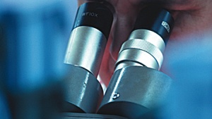 A scientist using a microscope.