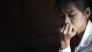 A woman with her chin resting on her hand.