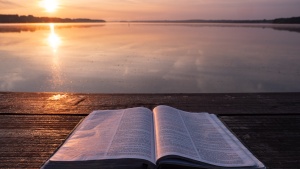 An open Bible laying on a table.