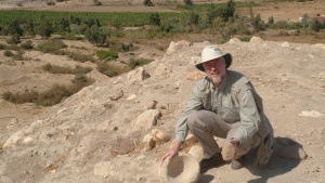 The author examines a stone grinder and bowl at Tall el-Hammam before excavations began.