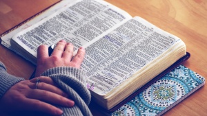 A woman reading a Bible.