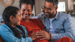 A family sitting together on a couch.