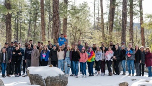 A group of young adults standing in the snow