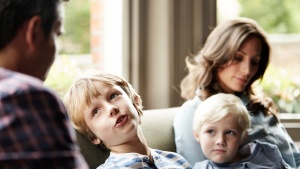 Parents talking to their young children.