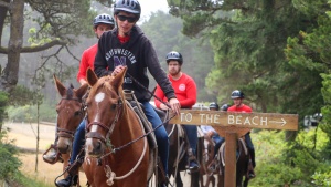 a group of teenagers riding horses
