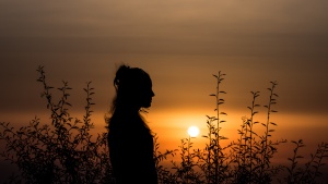 A silhouette of a young woman.