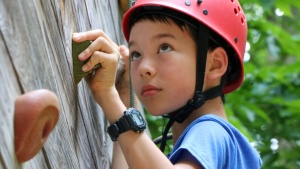 a boy climbing a rock wall