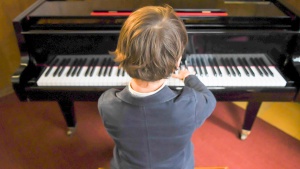 a boy playing a piano