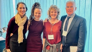 three women and a man smiling