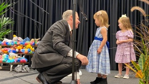 a member speaking with some of the children at the Feast