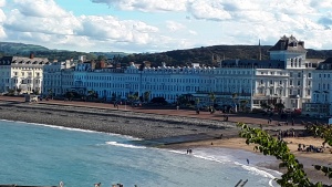 a white building with a beach in front on a cloudy day