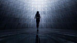 A woman surround by screens.