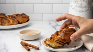 a hand reaching for a danish pastry