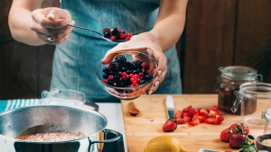 a person canning fruit in the kitchen