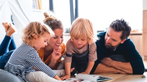 A family looking at a book.