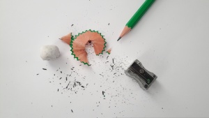 a pencil, a sharpener and a pencil shaving