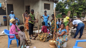 a group of brethren sitting outside a house in Ghana